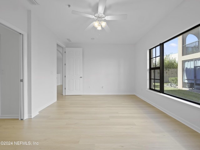 empty room with light hardwood / wood-style flooring and ceiling fan