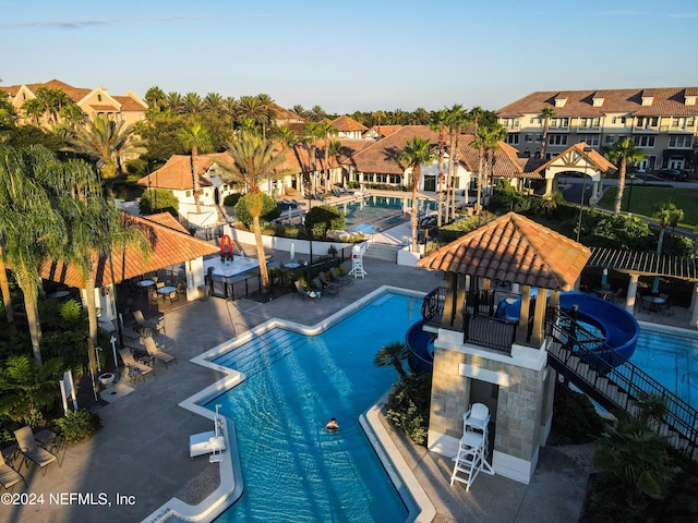 view of swimming pool with a gazebo, a patio area, and a water slide