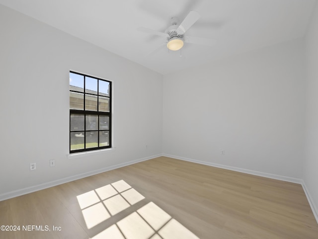 empty room featuring ceiling fan and light hardwood / wood-style floors