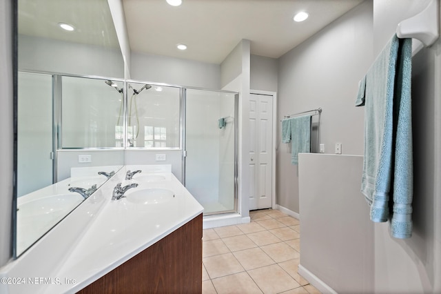 bathroom with tile patterned floors, vanity, and a shower with shower door