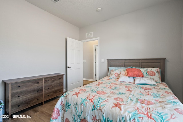 bedroom featuring dark hardwood / wood-style floors