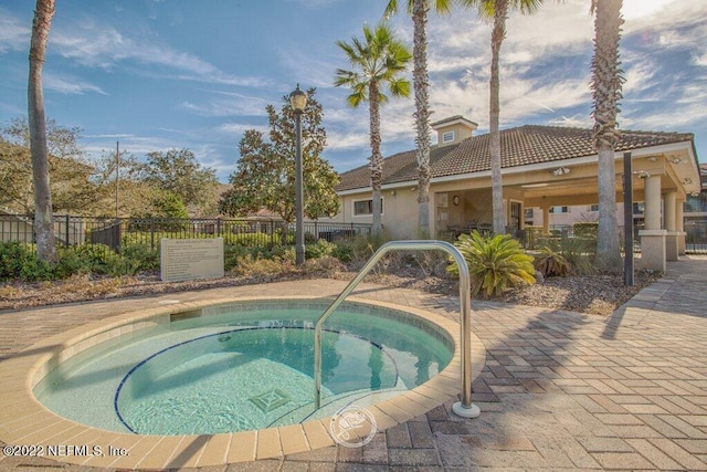 view of swimming pool with a hot tub