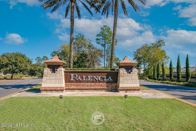 community / neighborhood sign featuring a lawn