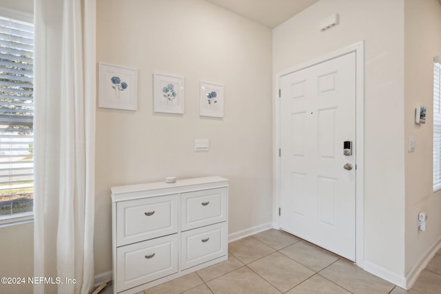 foyer featuring light tile patterned floors