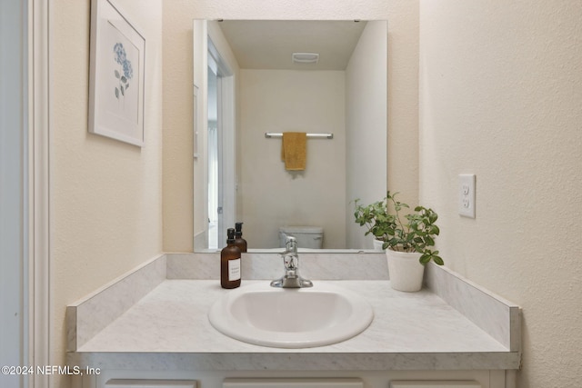 bathroom featuring vanity and toilet