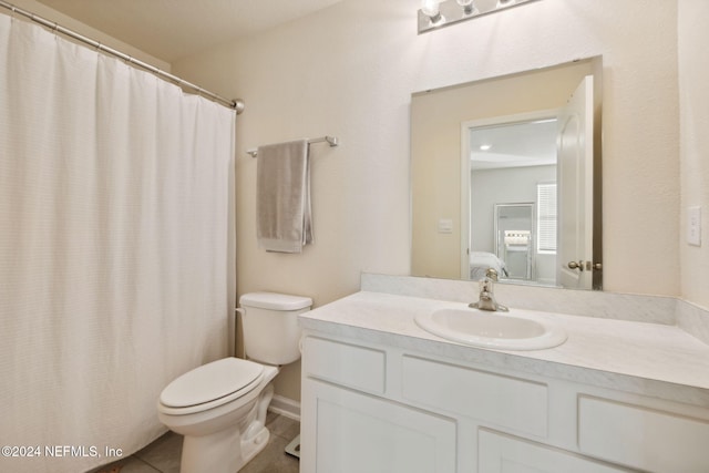 bathroom with tile patterned floors, vanity, and toilet