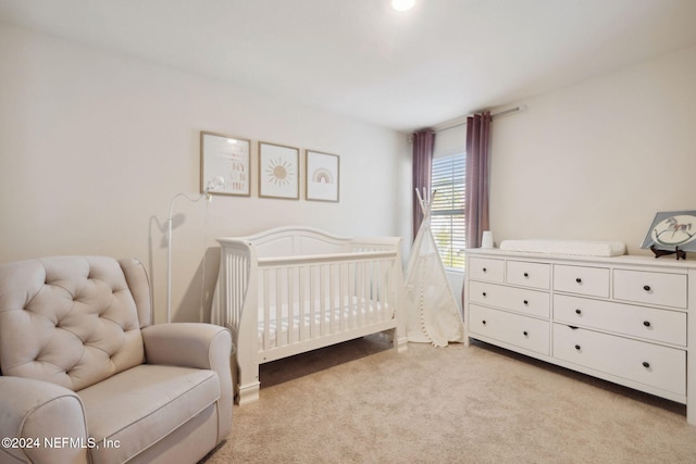 carpeted bedroom with a crib