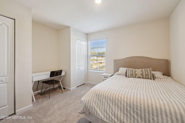 bedroom featuring light carpet