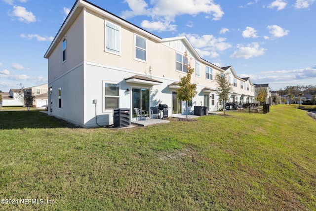 back of property featuring central AC, a patio area, and a lawn