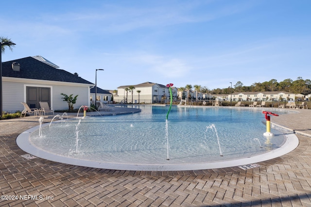 view of swimming pool featuring pool water feature