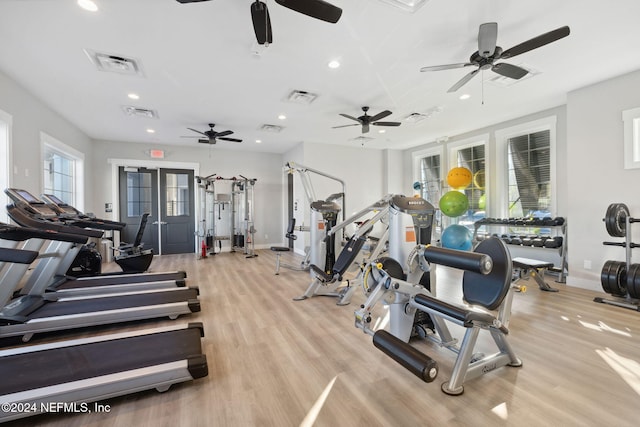 exercise room with light hardwood / wood-style floors