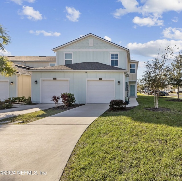 view of front of house with a garage and a front lawn