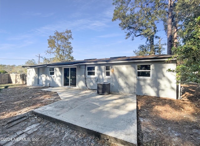 rear view of house featuring central AC unit and a patio area