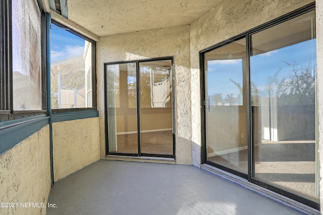 unfurnished sunroom featuring a mountain view