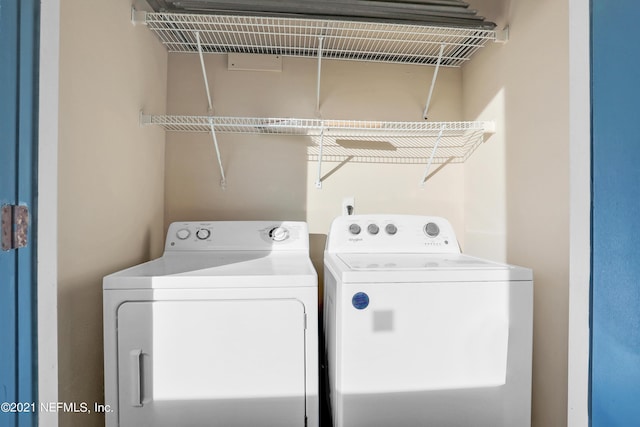 clothes washing area with washer and clothes dryer