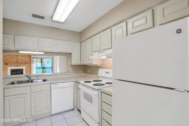 kitchen featuring sink, white cabinets, white appliances, and light tile patterned floors