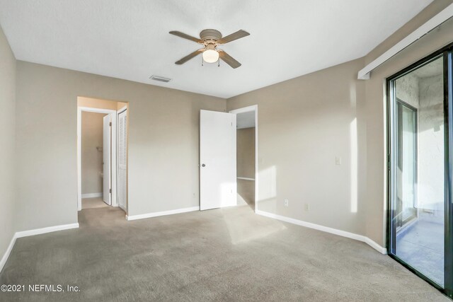 unfurnished bedroom featuring carpet, access to exterior, a closet, and ceiling fan