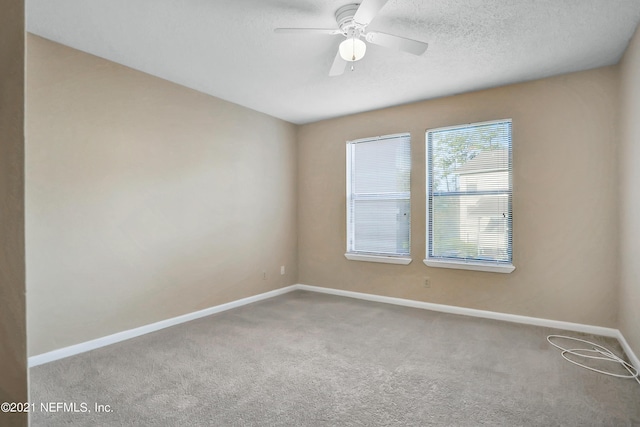 unfurnished room with carpet flooring, a textured ceiling, and ceiling fan