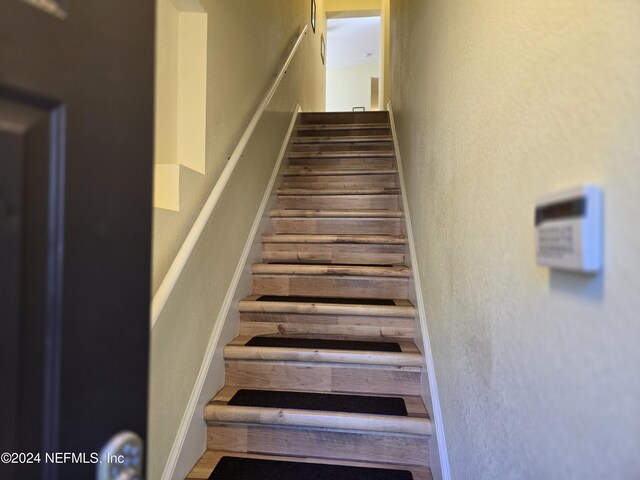 staircase featuring hardwood / wood-style flooring