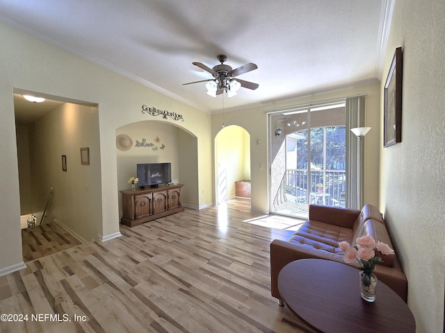 living room featuring ceiling fan, ornamental molding, and light hardwood / wood-style flooring