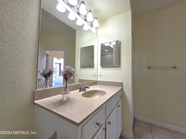 bathroom with tile patterned flooring and vanity