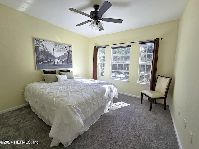 bedroom featuring ceiling fan and dark carpet