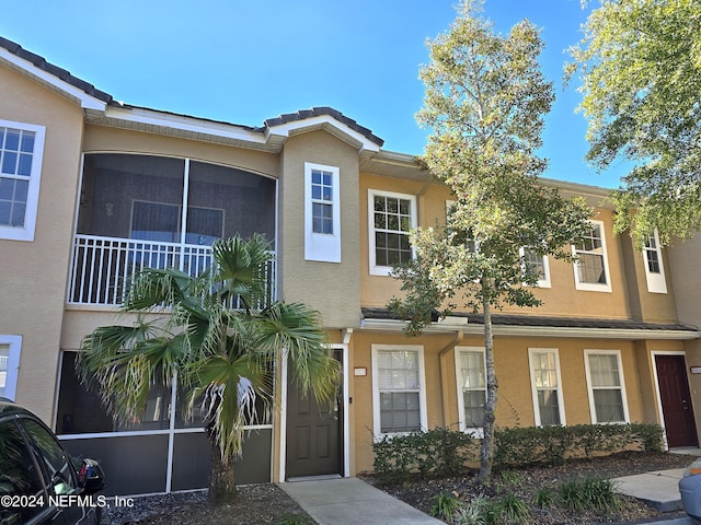 view of front of house featuring a sunroom