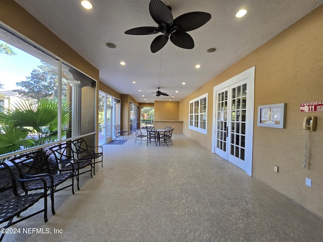 sunroom with french doors and ceiling fan