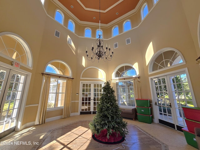 unfurnished sunroom with a chandelier and french doors