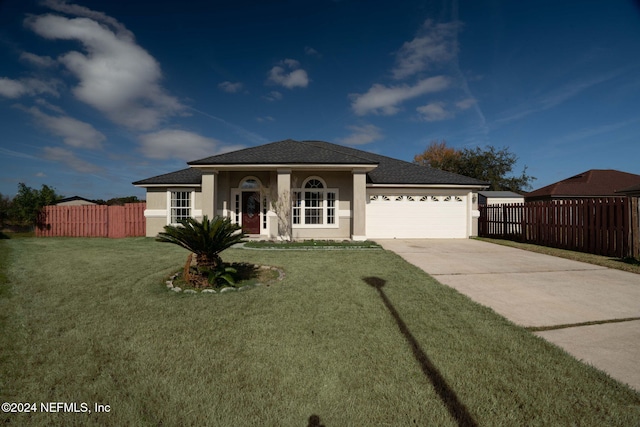 view of front facade featuring a garage and a front lawn