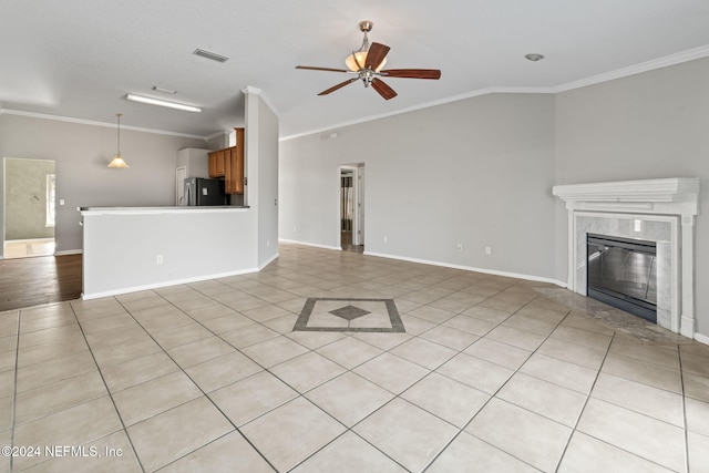 unfurnished living room featuring crown molding, a fireplace, ceiling fan, and light tile patterned flooring