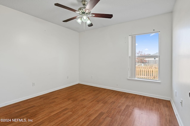 empty room featuring ceiling fan and wood-type flooring