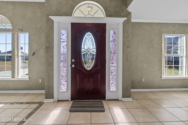 tiled entrance foyer with crown molding