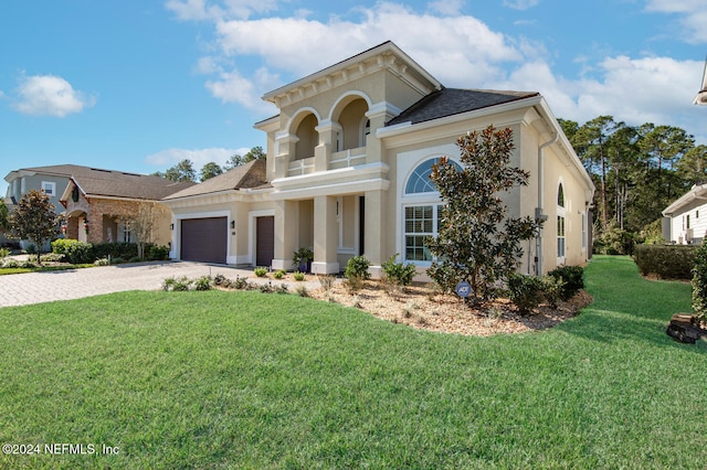 view of front of house with a front yard and a garage