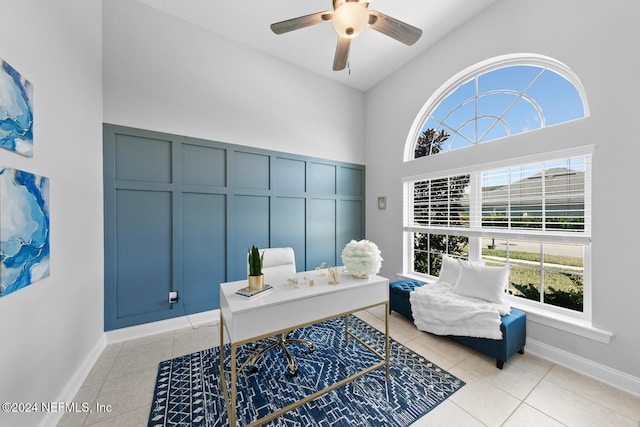 tiled home office featuring ceiling fan