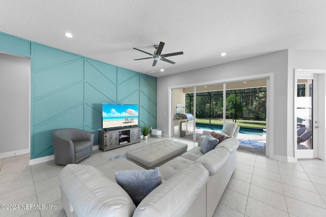 tiled living room with ceiling fan and a textured ceiling