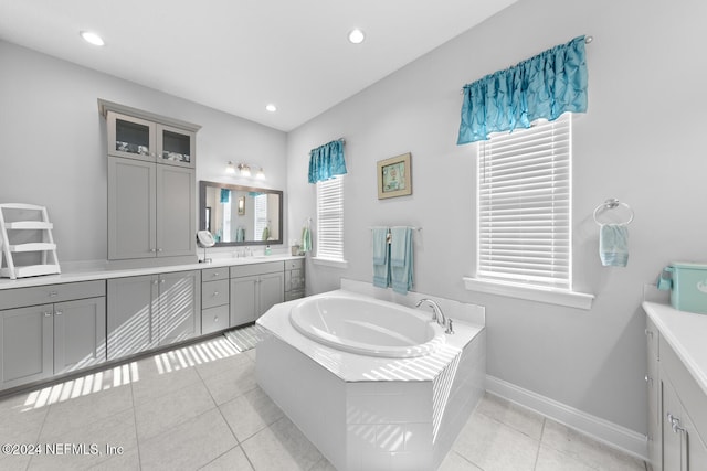 bathroom featuring tile patterned floors, a bathtub, and vanity