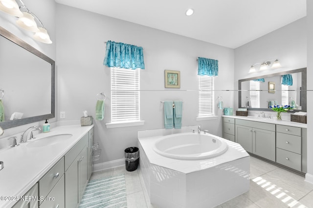 bathroom featuring vanity, tiled bath, and tile patterned floors