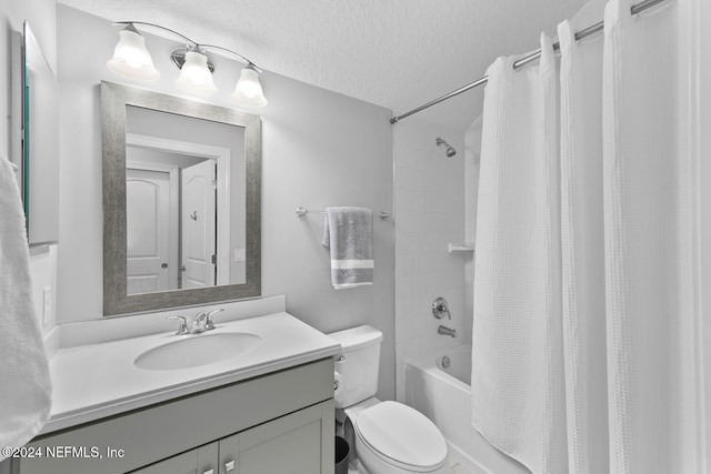 full bathroom with shower / bath combo with shower curtain, vanity, a textured ceiling, and toilet