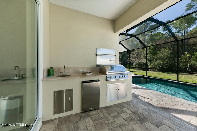 view of patio / terrace with area for grilling, sink, glass enclosure, and grilling area