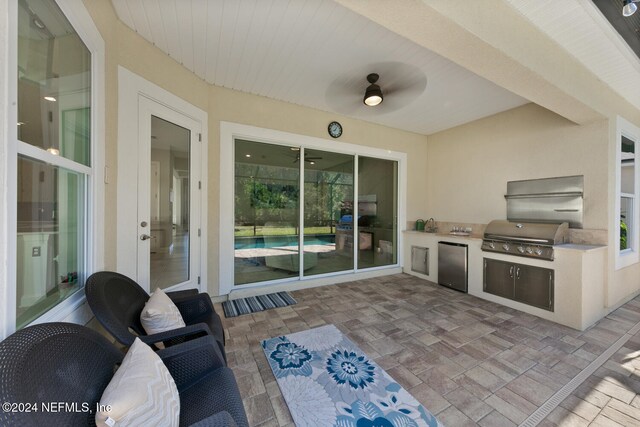 view of patio / terrace featuring ceiling fan, exterior kitchen, and grilling area