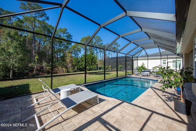 view of swimming pool with a patio area, a lanai, and a yard