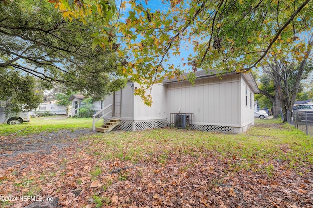 view of side of home with central AC unit