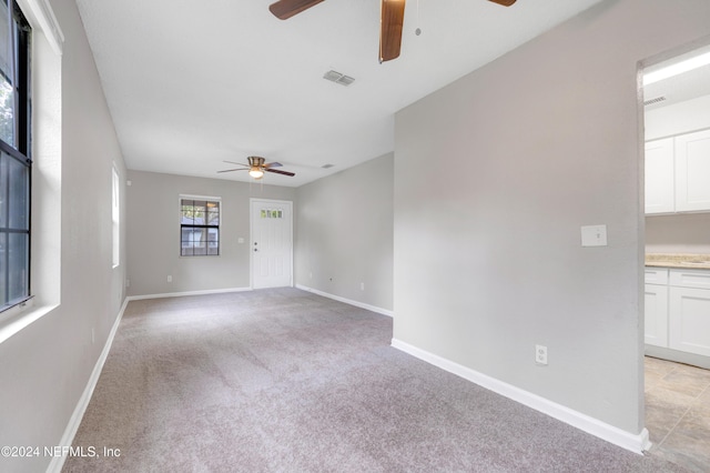 unfurnished room featuring light colored carpet