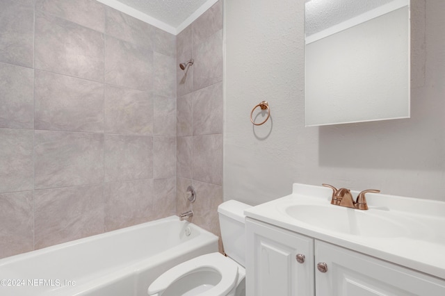 full bathroom with vanity, a textured ceiling, toilet, and tiled shower / bath