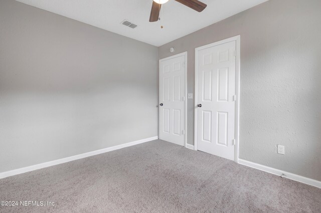 unfurnished bedroom featuring carpet flooring and ceiling fan