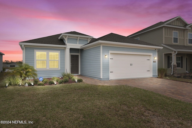 craftsman house featuring a garage and a yard