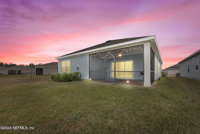 back house at dusk with a yard