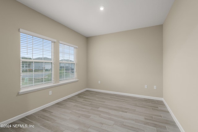 spare room featuring light wood-type flooring