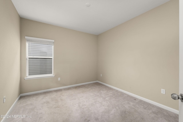 spare room with light carpet